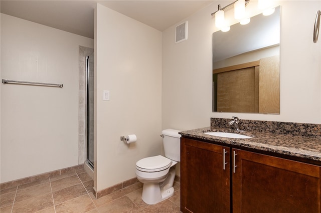 bathroom featuring vanity, walk in shower, toilet, and tile patterned flooring