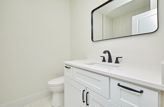 bathroom with tile patterned floors, vanity, toilet, and baseboards