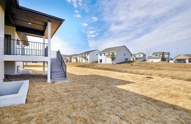 view of yard featuring stairs and a residential view