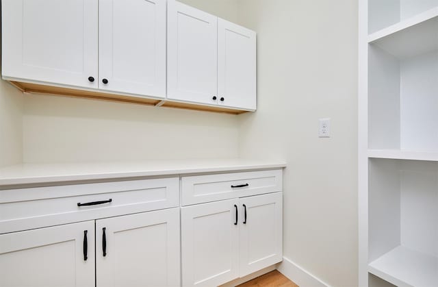 interior space featuring light wood-type flooring and baseboards