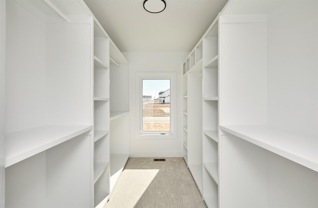 walk in closet featuring carpet flooring