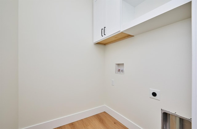 laundry room featuring cabinet space, light wood finished floors, baseboards, hookup for a washing machine, and hookup for an electric dryer