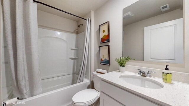 full bathroom featuring vanity, shower / tub combo with curtain, and toilet