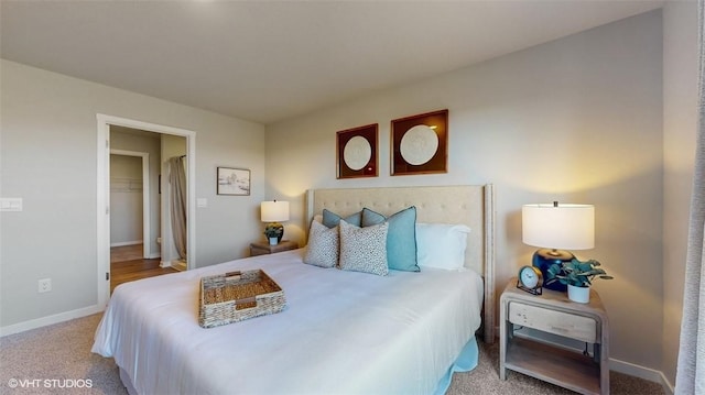 bedroom with a spacious closet and light carpet