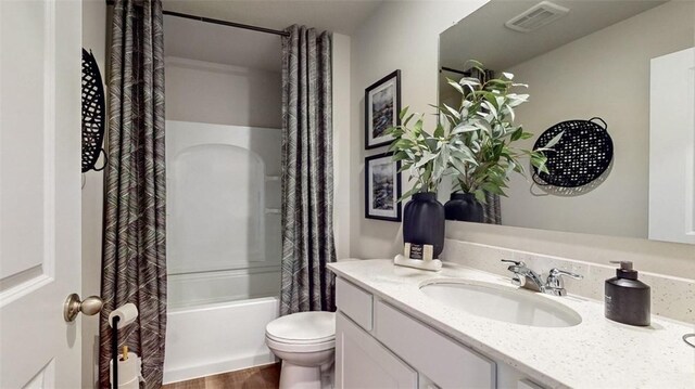 full bathroom with toilet, shower / tub combo with curtain, vanity, and hardwood / wood-style flooring