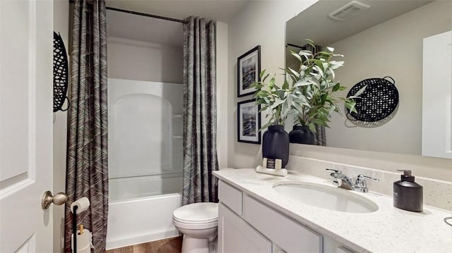 full bathroom featuring vanity, shower / bathtub combination with curtain, and toilet