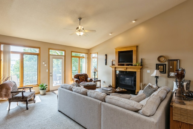 living room with carpet, lofted ceiling, and ceiling fan