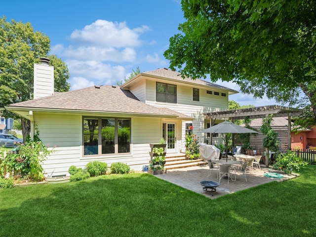 rear view of property with a patio area and a yard