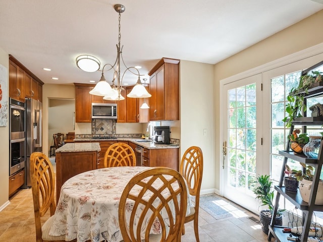 dining room with recessed lighting, baseboards, and an inviting chandelier