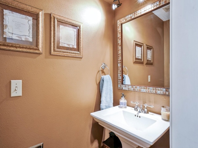 bathroom with visible vents and a sink