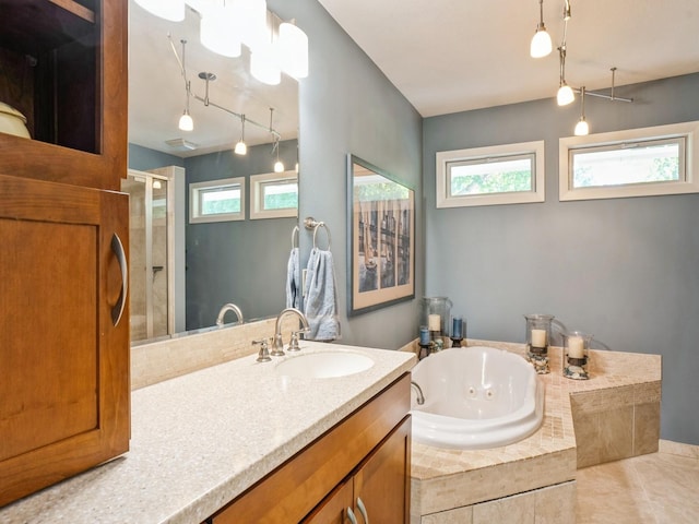 full bathroom with vanity, a healthy amount of sunlight, a stall shower, and a whirlpool tub