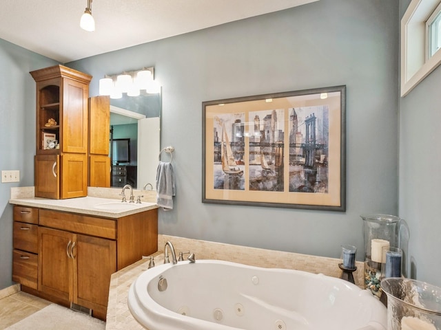 full bath featuring vanity, tile patterned floors, and a tub with jets