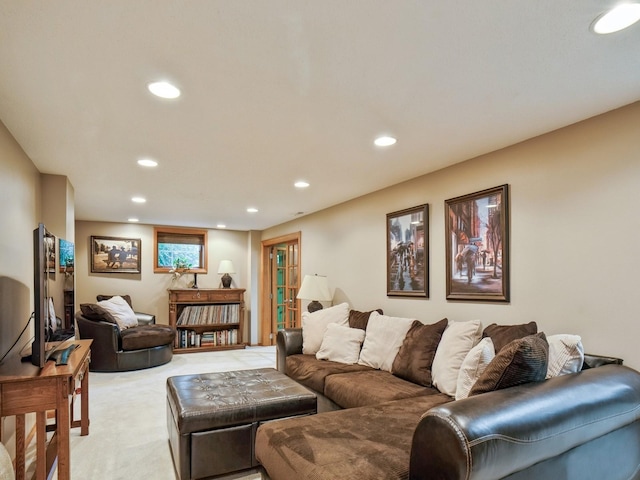 living area featuring recessed lighting and light carpet