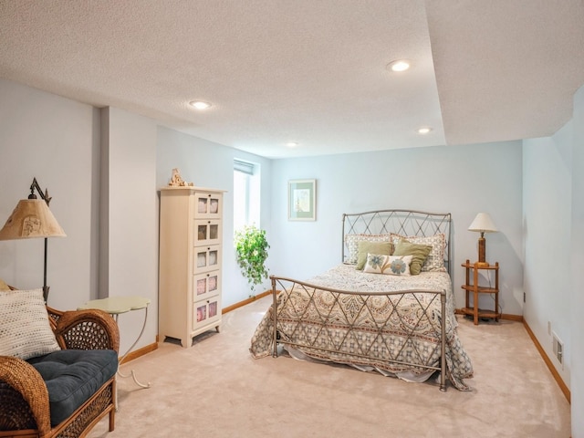 bedroom featuring visible vents, baseboards, light carpet, recessed lighting, and a textured ceiling