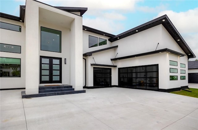 contemporary house with stucco siding and concrete driveway