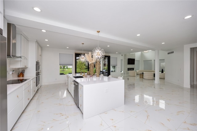 kitchen featuring stainless steel appliances, pendant lighting, wall chimney range hood, light tile patterned floors, and a center island