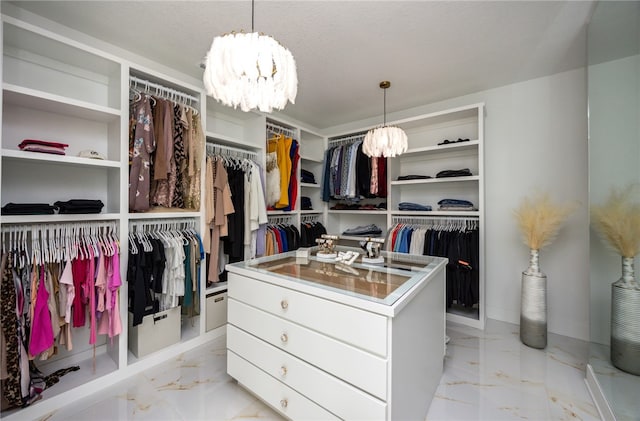 spacious closet featuring light tile patterned floors and an inviting chandelier