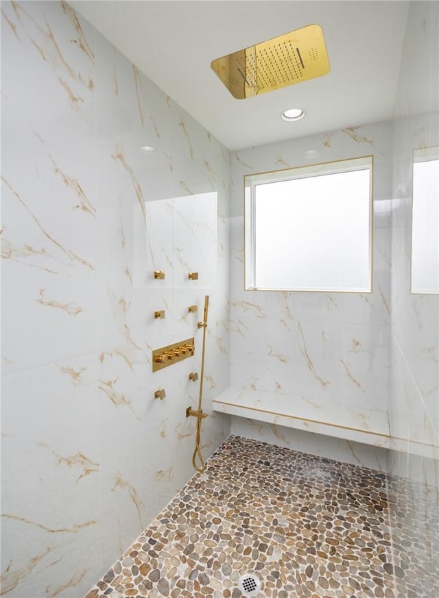 bathroom with a marble finish shower