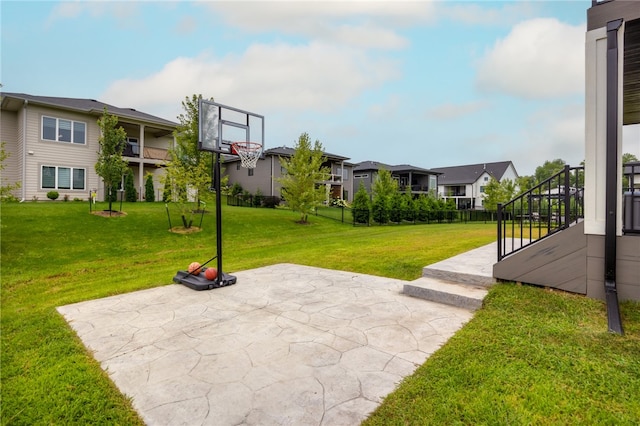 view of basketball court featuring a yard