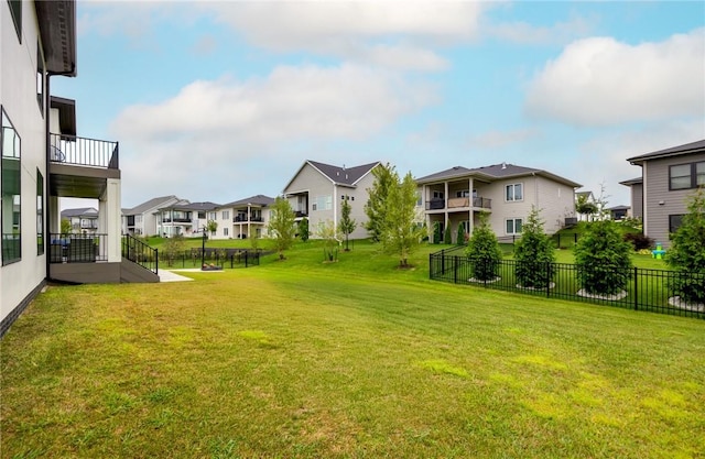 view of yard featuring a residential view and fence