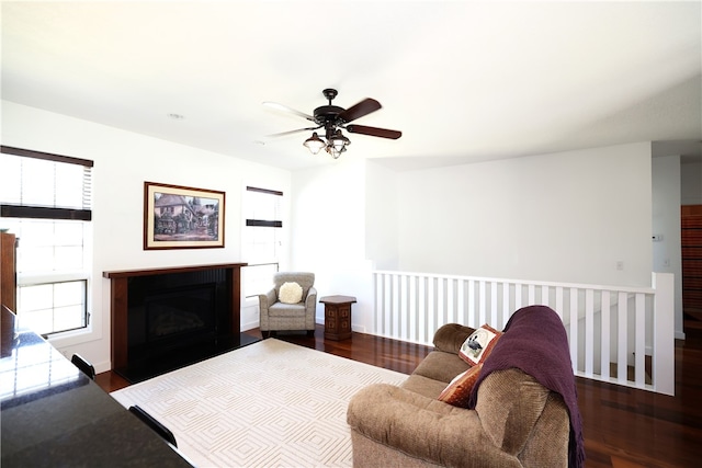 living room featuring ceiling fan and dark wood-type flooring