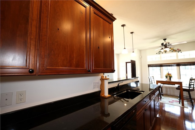 kitchen with ceiling fan, dark hardwood / wood-style flooring, dishwasher, sink, and decorative light fixtures