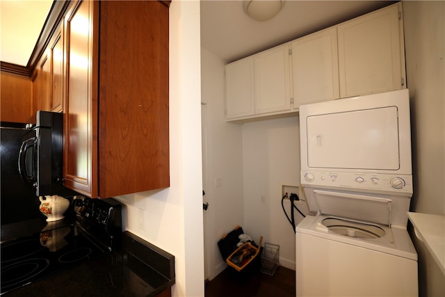 laundry room featuring stacked washer / drying machine