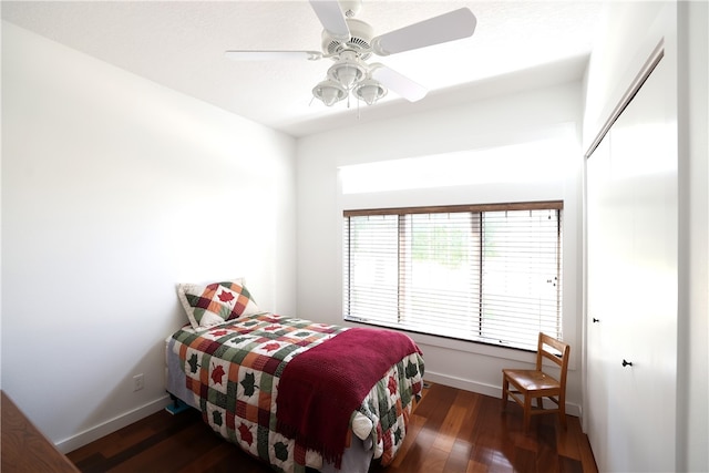 bedroom featuring ceiling fan, dark wood-type flooring, and a closet