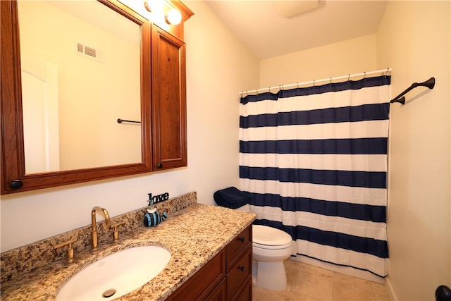 bathroom with toilet, tile patterned floors, and vanity