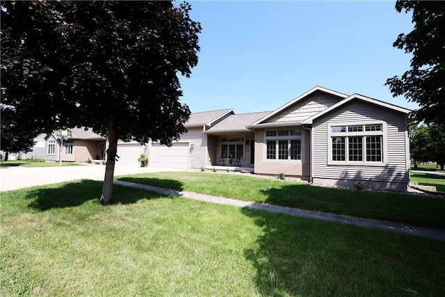 view of front of home with a garage and a front lawn