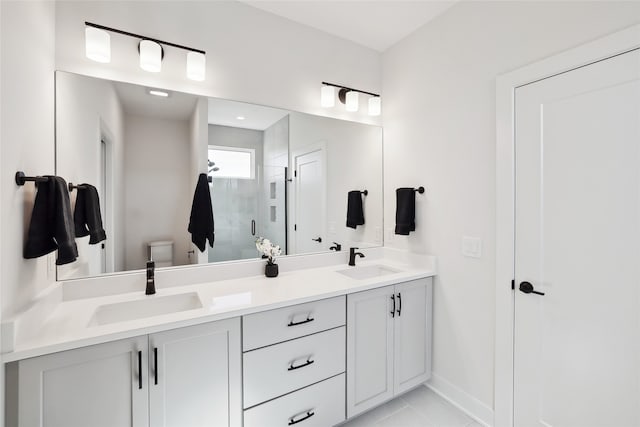 bathroom featuring vanity, tile patterned flooring, an enclosed shower, and toilet