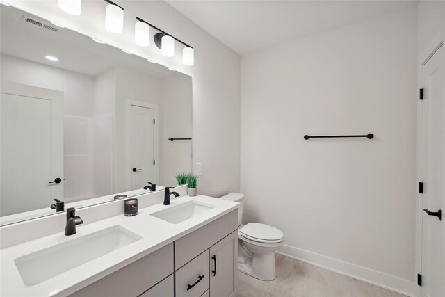 bathroom featuring vanity and toilet