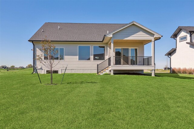 rear view of property with a lawn