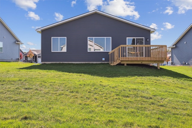 rear view of property featuring a yard and a deck