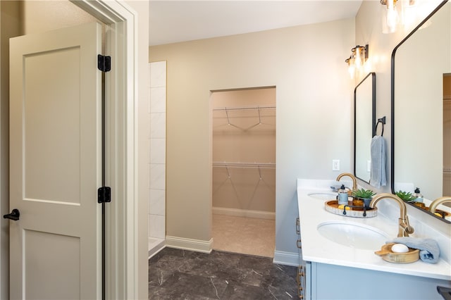 bathroom featuring tile patterned flooring, double sink vanity, and walk in shower