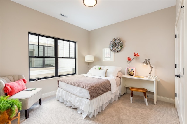 bedroom featuring light colored carpet