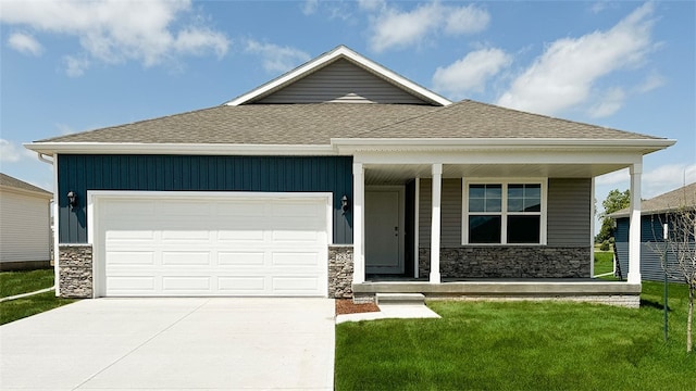 view of front of home with driveway, a shingled roof, stone siding, an attached garage, and a porch