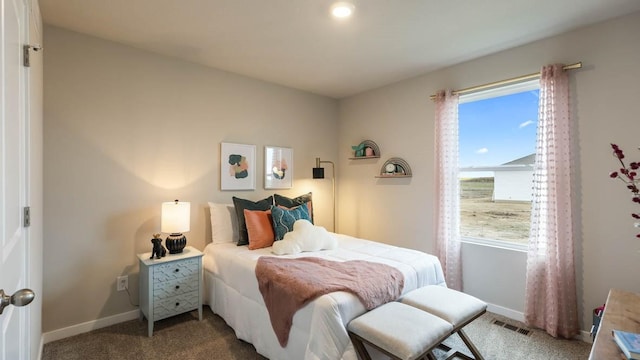 carpeted bedroom featuring visible vents and baseboards