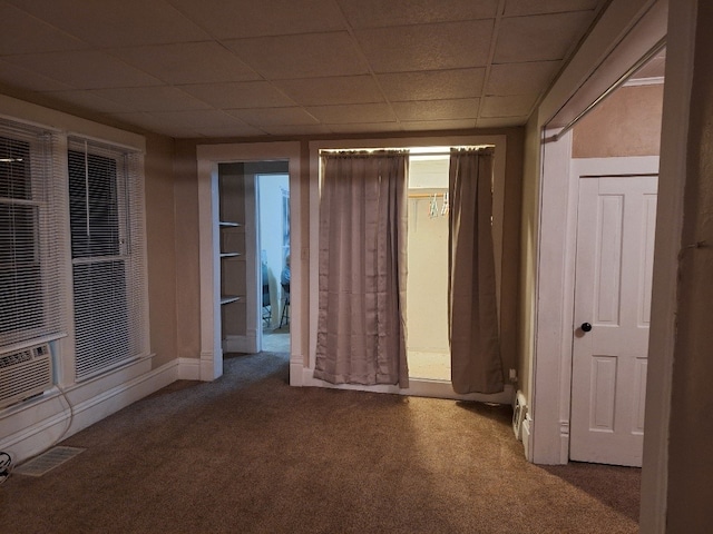 spare room with carpet and a drop ceiling