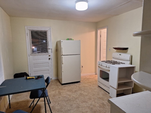 kitchen featuring light tile patterned floors and white appliances