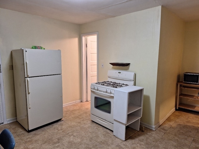317 7th St, West Des Moines, IA 50265 - kitchen with white appliances, baseboards, and light tile patterned flooring