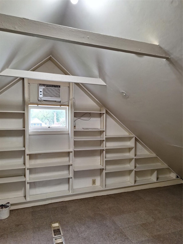 317 7th St, West Des Moines, IA 50265 - additional living space with dark colored carpet, vaulted ceiling, and a wall mounted AC