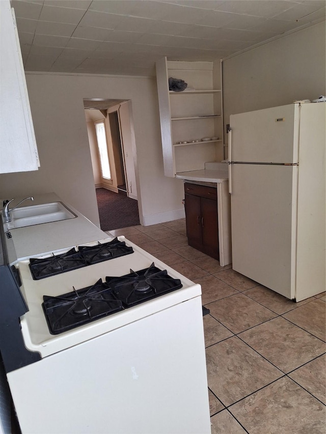 317 7th St, West Des Moines, IA 50265 - kitchen with white appliances, a sink, light tile patterned floors, light countertops, and open shelves