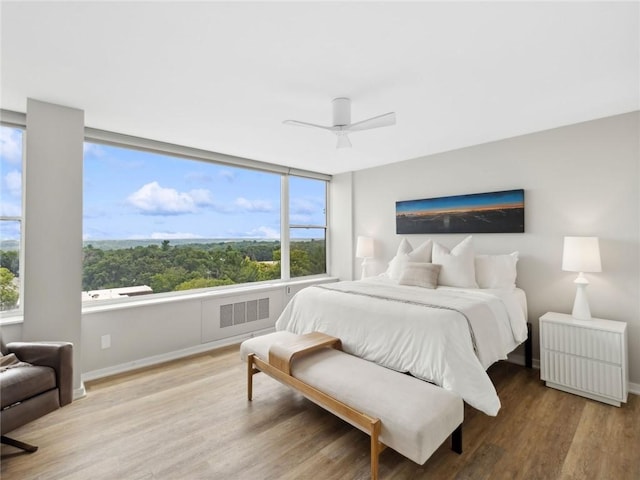 bedroom with ceiling fan and wood-type flooring