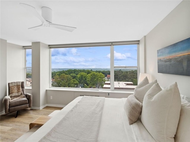 bedroom with ceiling fan and light hardwood / wood-style flooring