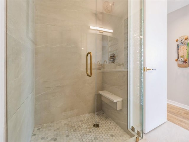 bathroom with a shower with door