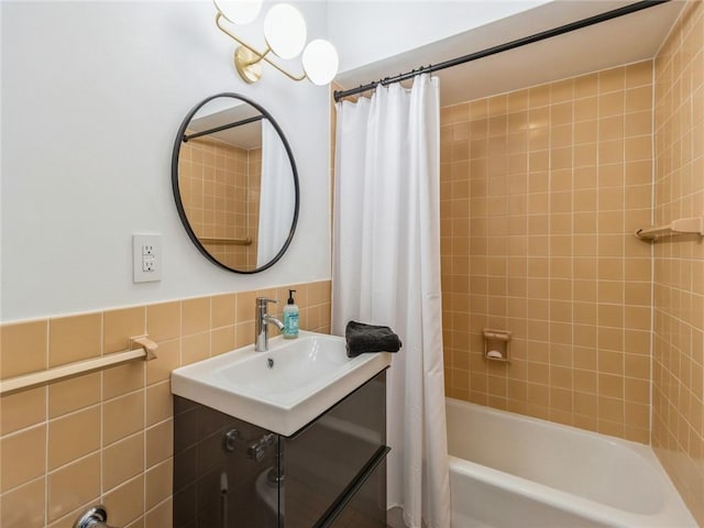 bathroom with tile walls, sink, and shower / bath combo