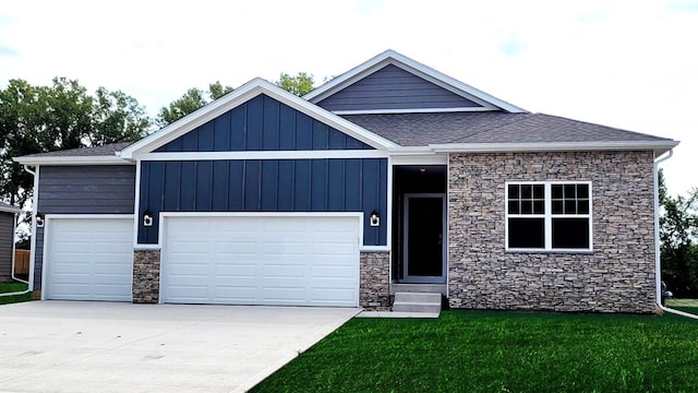 view of front of home with board and batten siding, entry steps, a front yard, driveway, and an attached garage