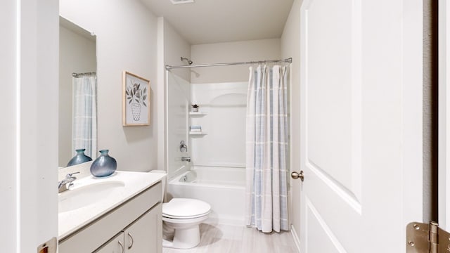 full bath with toilet, vanity, and shower / tub combo