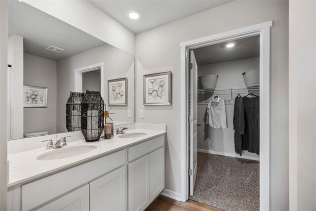 bathroom featuring hardwood / wood-style flooring, vanity, and toilet